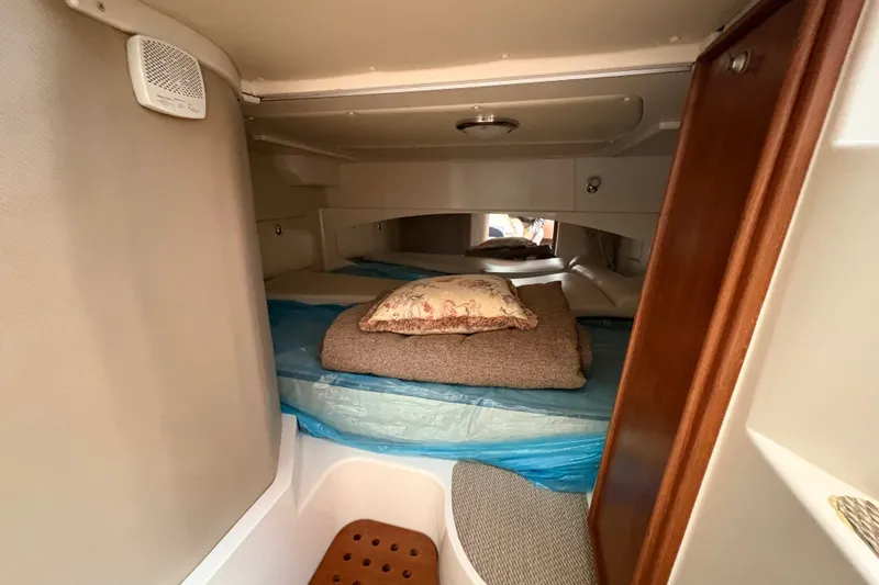 Slide: The Image of 2007 Grady-White Express 360 cabin interior with bedding and wooden accents. - 20