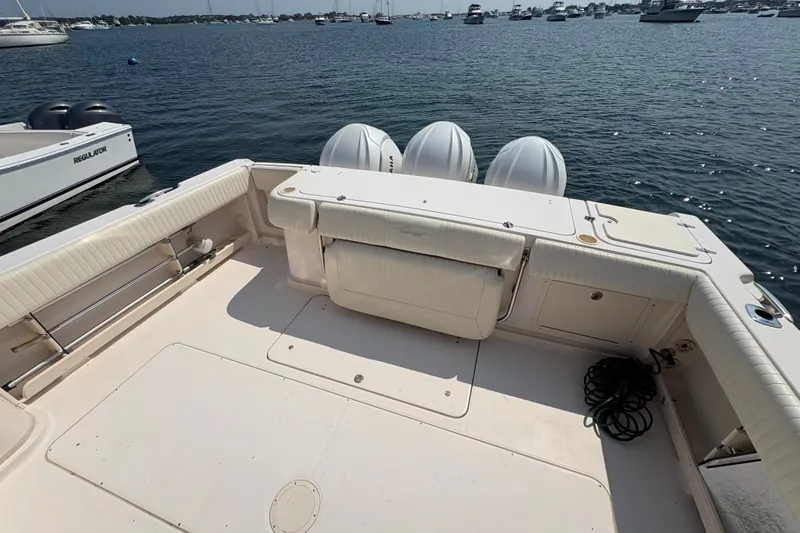 Slide: The Image of 2007 Grady-White Express 360 boat deck with triple outboard motors on calm water. - 11