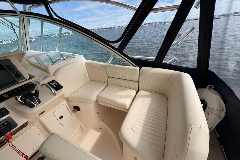 Slide: The Image of 2007 Grady-White Express 360 boat interior with cream seating and control panel. - 18