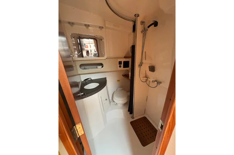 Slide: The Image of 2007 Grady-White Express 360 boat bathroom with shower, sink, and toilet. - 23