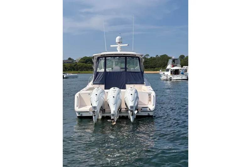 Slide: The Image of 2007 Grady-White Express 360 boat with triple outboard engines on water. - 10