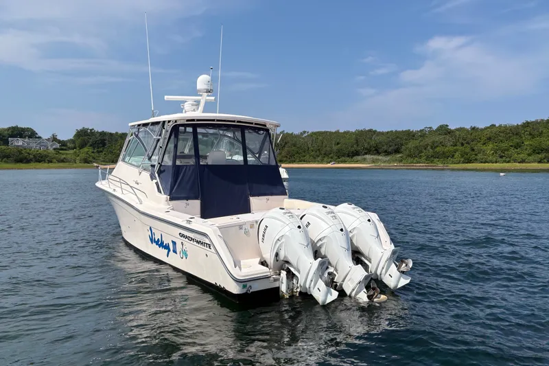 Slide: The Image of 2007 Grady-White Express 360 boat with triple Yamaha engines on calm water. - 8