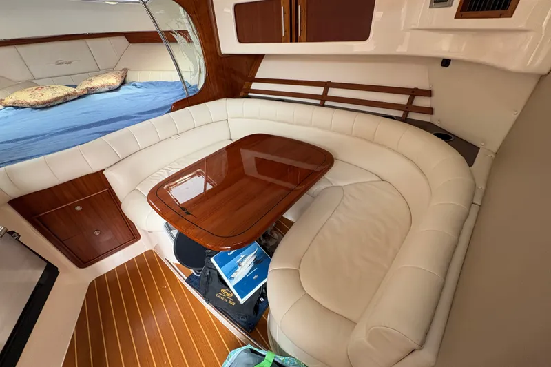 Slide: The Image of Luxurious 2007 Grady-White Express 360 cabin with white leather seating and wooden table. - 25