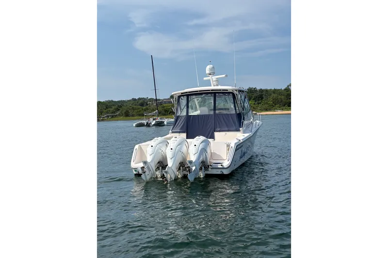 Slide: The Image of 2007 Grady-White Express 360 boat with triple outboard motors on water. - 9