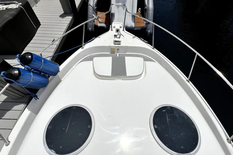 Slide: The Image of Top view of a 2004 Century 3200 Walk-Around boat docked with blue fenders. - 54