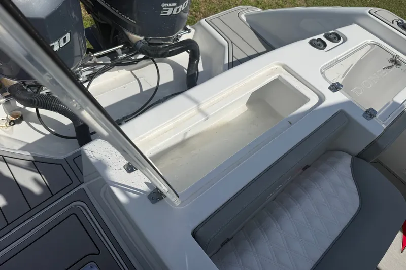 Slide: The Image of 2004 Donzi 29 ZF Open boat interior with Yamaha engines and storage compartment. - 53