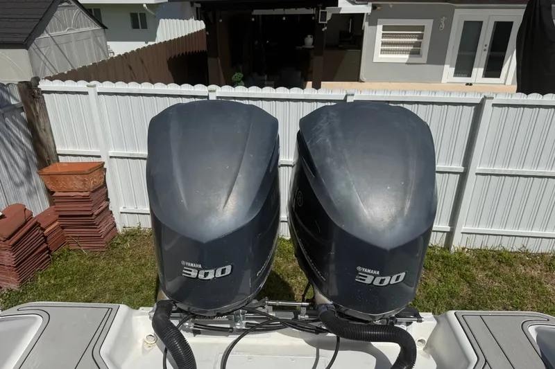 Slide: The Image of Twin Yamaha 300 engines on a 2004 Donzi 29 ZF Open boat, parked in a yard. - 22