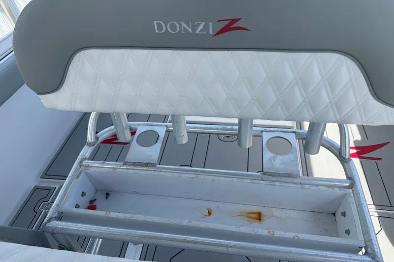 Slide: The Image of 2004 Donzi 29 ZF Open boat seat with rod holders and storage compartment. - 51