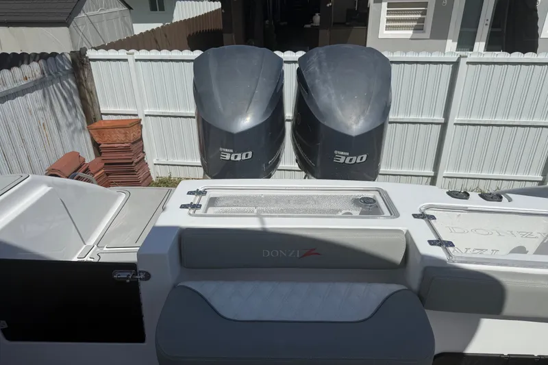 Slide: The Image of 2004 Donzi 29 ZF Open boat with twin Yamaha 300 engines, docked in a yard. - 21