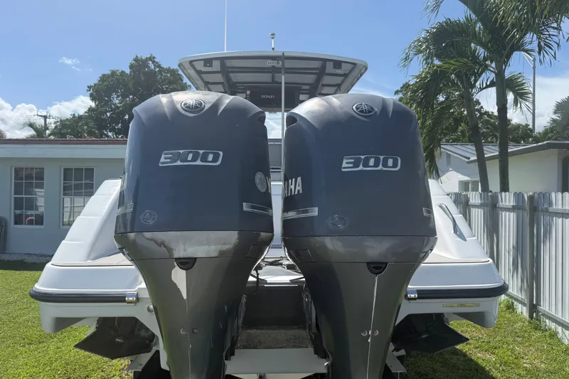 Slide: The Image of 2004 Donzi 29 ZF Open with twin Yamaha 300 engines, parked outdoors. - 10