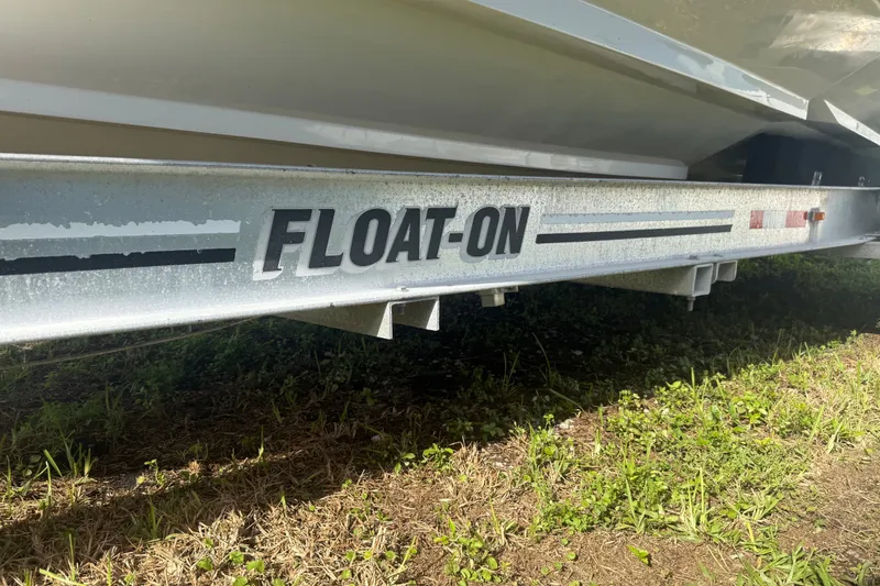 Slide: The Image of Trailer for 2004 Donzi 29 ZF Open boat, labeled "FLOAT-ON," on grassy ground. - 18