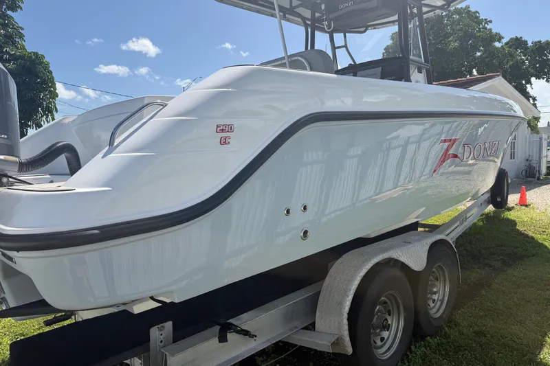 Slide: The Image of 2004 Donzi 29 ZF Open boat on trailer under clear blue sky. - 2