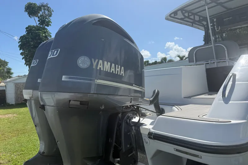 Slide: The Image of 2004 Donzi 29 ZF Open boat with Yamaha outboard engines in a sunny yard. - 12