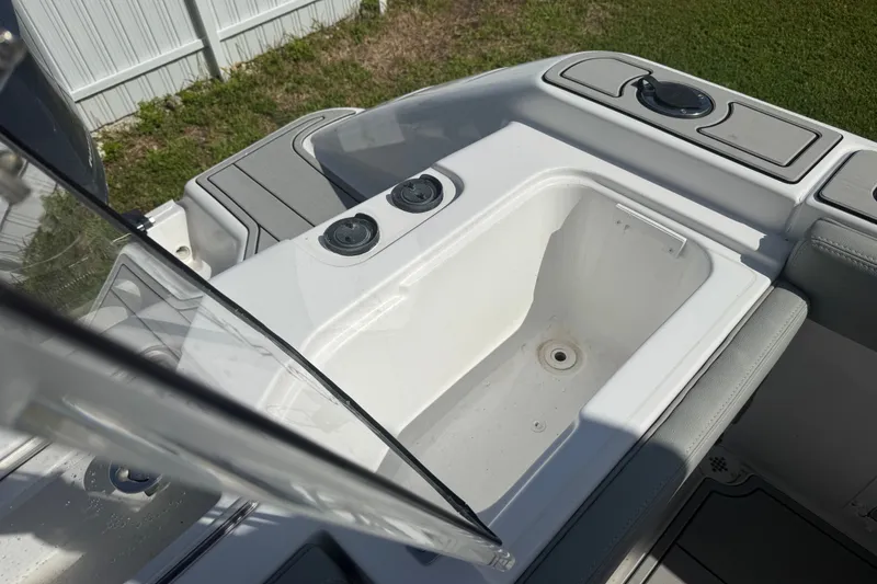 Slide: The Image of 2004 Donzi 29 ZF Open boat interior with storage compartment and seating. - 55