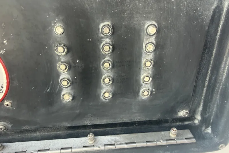 Slide: The Image of Control panel of a 2004 Donzi 29 ZF Open boat with multiple switches. - 35