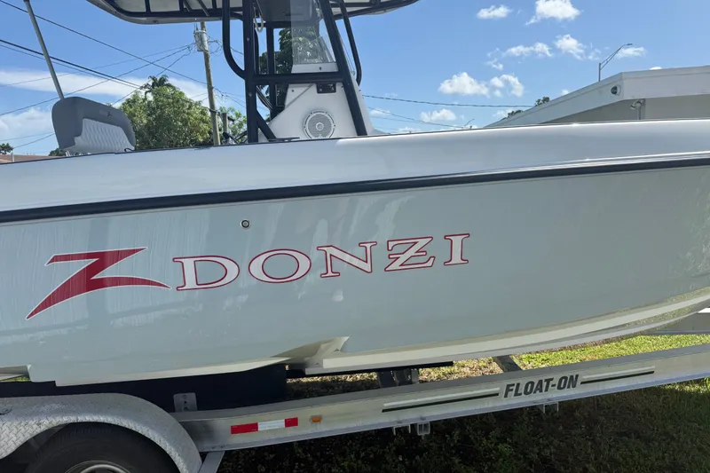 Slide: The Image of 2004 Donzi 29 ZF Open boat on trailer, side view with logo visible. - 1