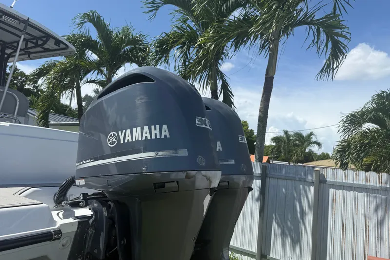 Slide: The Image of 2004 Donzi 29 ZF Open with Yamaha outboard engines, surrounded by palm trees. - 11