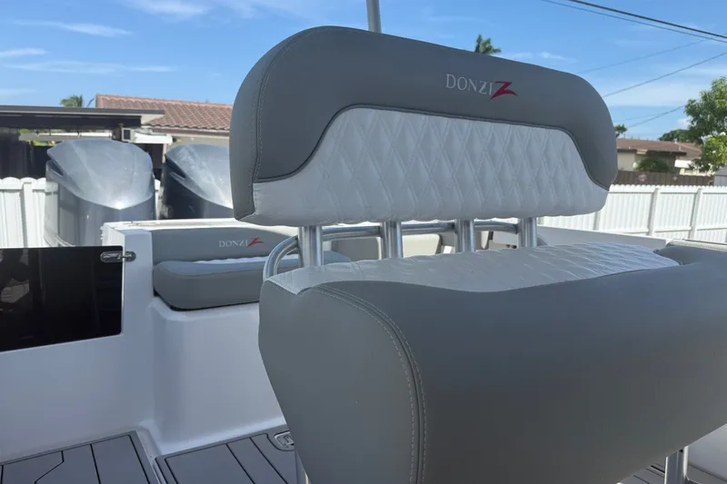 Slide: The Image of 2004 Donzi 29 ZF Open boat interior with gray and white seating. - 24