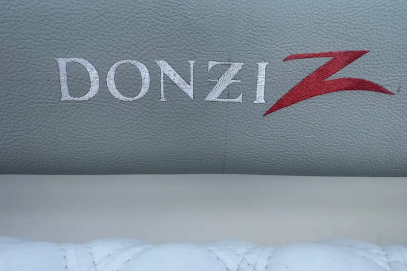 Slide: The Image of Donzi 29 ZF Open 2004 logo on gray leather upholstery. - 52