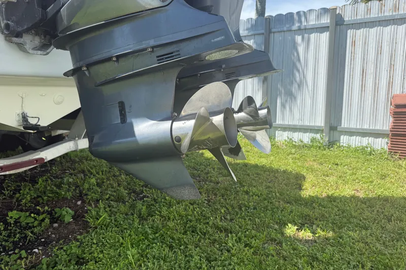 Slide: The Image of Close-up of a 2004 Donzi 29 ZF Open boat propeller on grass. - 14