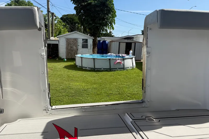 Slide: The Image of View from a 2004 Donzi 29 ZF Open boat, overlooking a backyard with a pool. - 27