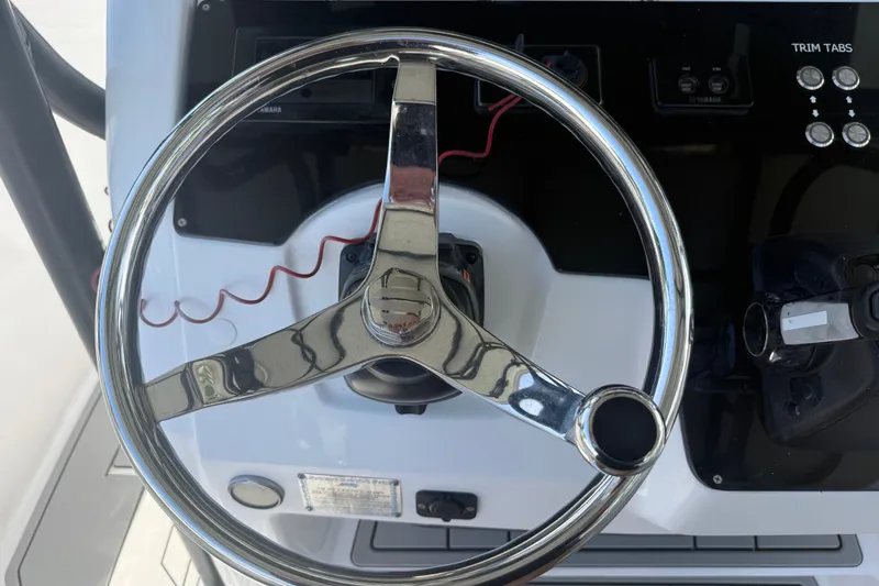 Slide: The Image of Steering wheel of a 2004 Donzi 29 ZF Open boat with control panel. - 32