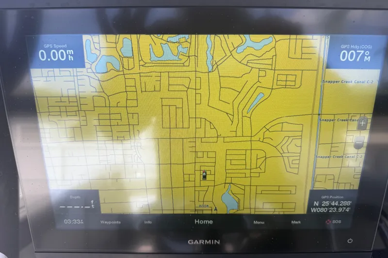 Slide: The Image of Garmin GPS display on a 2004 Donzi 29 ZF Open boat, showing map and coordinates. - 30