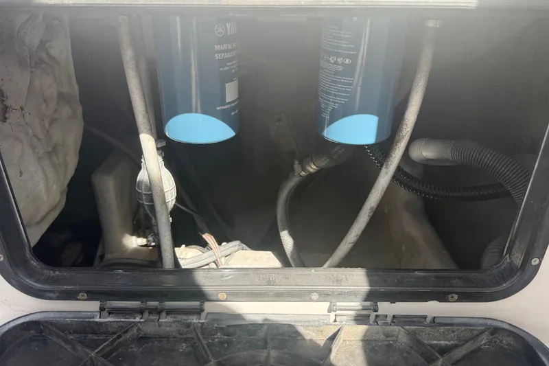 Slide: The Image of Engine compartment of a 2004 Donzi 29 ZF Open boat with visible filters and hoses. - 58