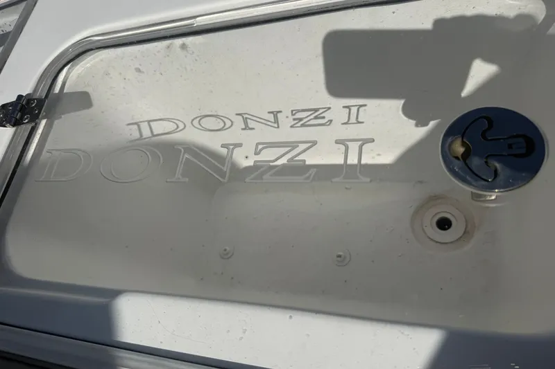 Slide: The Image of 2004 Donzi 29 ZF Open boat hatch with embossed logo and latch. - 54