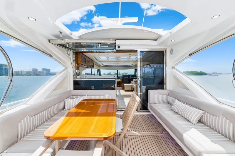 Slide: The Image of  Riviera 6000 Sport Yacht - cockpit, sunroof open.  - 21