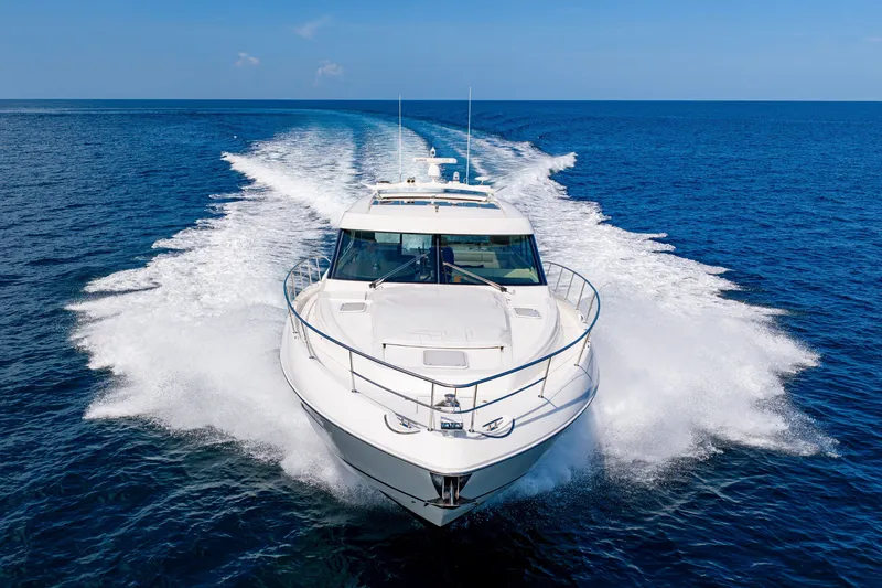 Slide: The Image of 2019 Riviera 6000 Sport Yacht cruising on open blue ocean waters. - 14