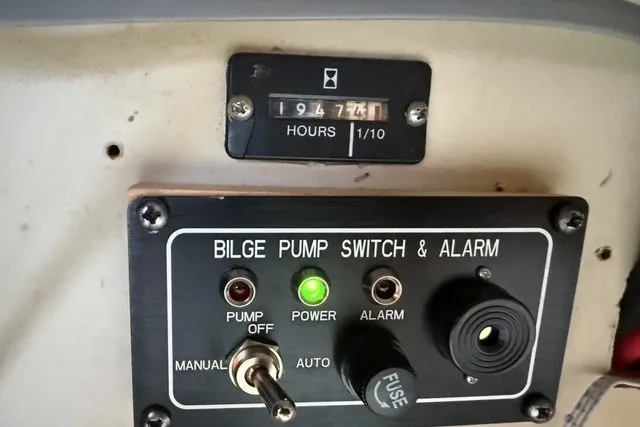 Slide: The Image of Control panel of a 1981 C&C Landfall 38 sailboat with bilge pump switch and hour meter. - 24