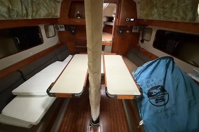 Slide: The Image of Interior of 1981 C&C Landfall 38 sailboat with wooden furnishings and seating area. - 17