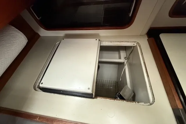Slide: The Image of 1981 C&C Landfall 38 yacht interior with open storage compartment. - 15
