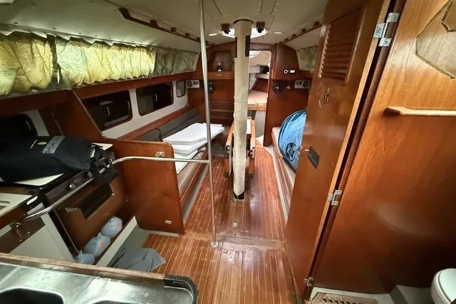 Slide: The Image of Interior of 1981 C&C Landfall 38 sailboat with wooden finishes and cozy cabin layout. - 13