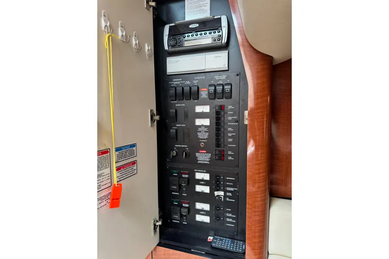 Slide: The Image of Electrical control panel inside a 2004 Sea Ray 340 Sundancer boat, featuring various switches and controls. - 32