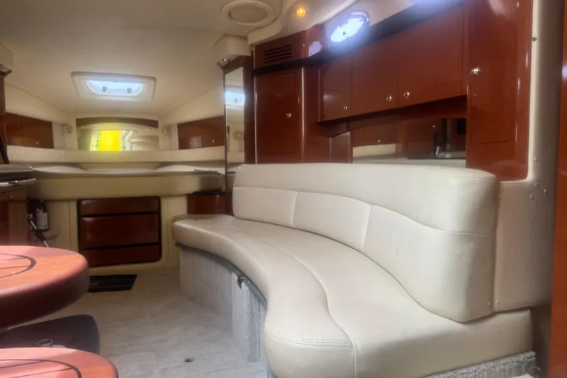 Slide: The Image of Interior of 2004 Sea Ray 340 Sundancer yacht with beige seating and wooden cabinetry. - 27