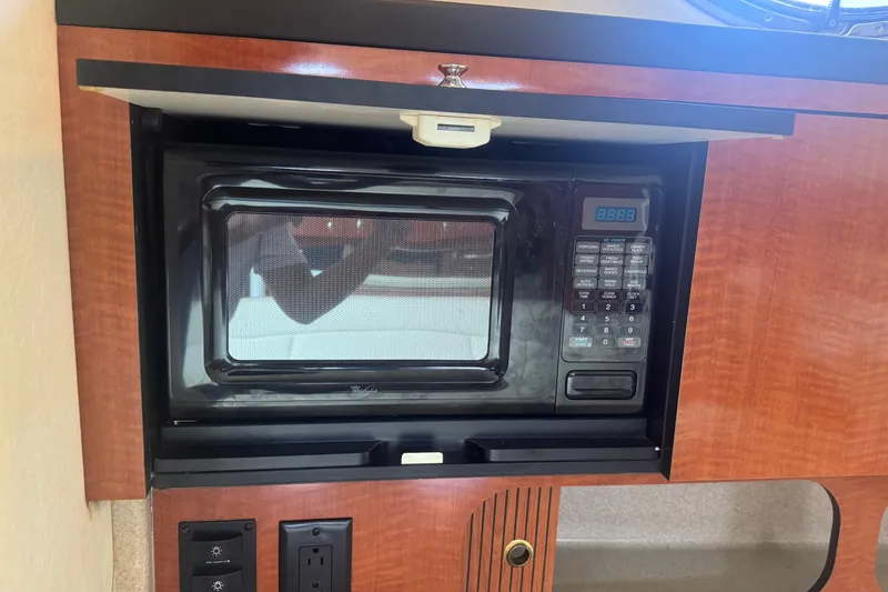 Slide: The Image of Microwave in 2004 Sea Ray 340 Sundancer yacht kitchen, wood cabinetry. - 26