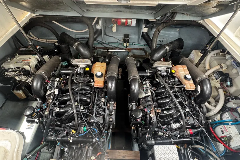 Slide: The Image of Engine room of a 2004 Sea Ray 340 Sundancer with dual engines and mechanical components. - 34