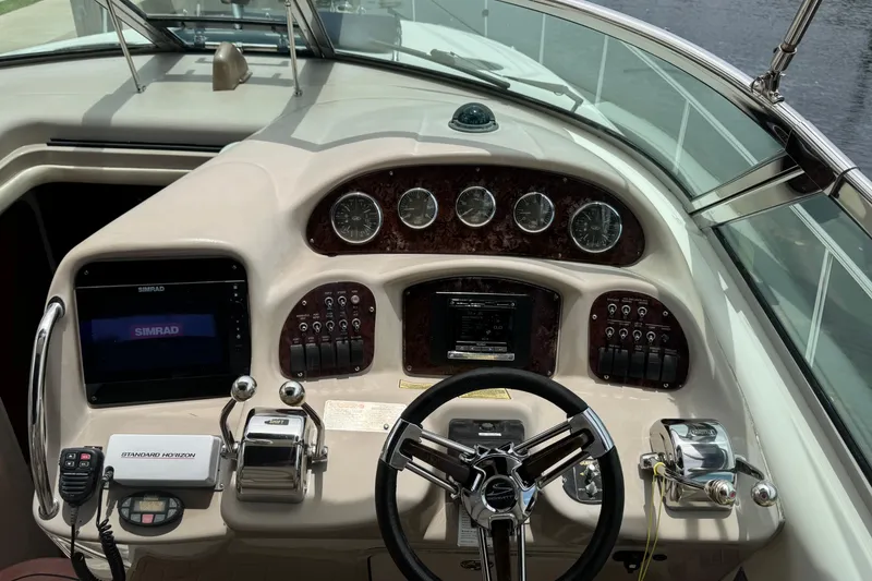 Slide: The Image of 2004 Sea Ray 340 Sundancer helm with gauges, controls, and navigation equipment. - 20