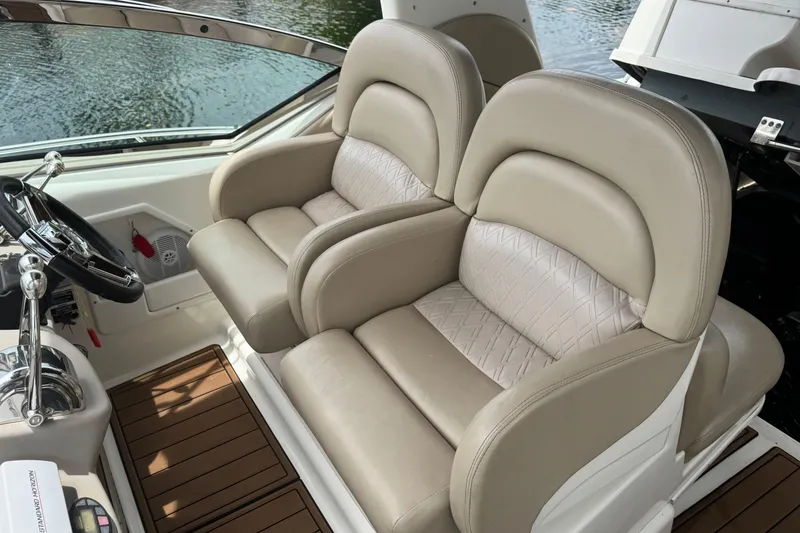 Slide: The Image of Luxurious seating on a 2004 Sea Ray 340 Sundancer boat, featuring beige leather upholstery. - 18