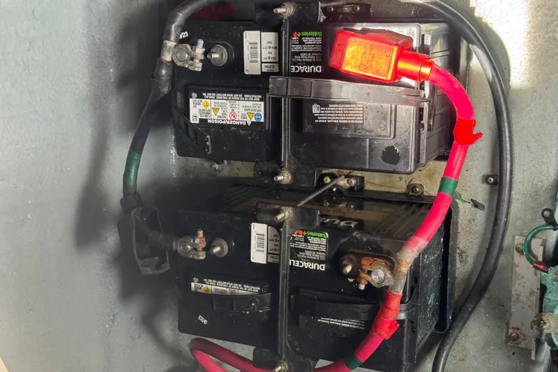 Slide: The Image of Battery compartment of a 2004 Sea Ray 340 Sundancer with connected cables. - 36