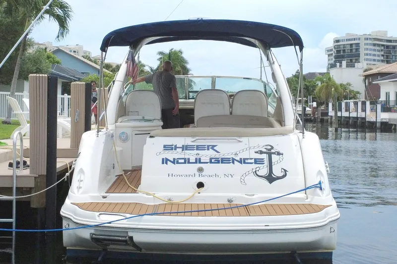 Slide: The Image of 2004 Sea Ray 340 Sundancer docked in a scenic waterfront setting. - 4
