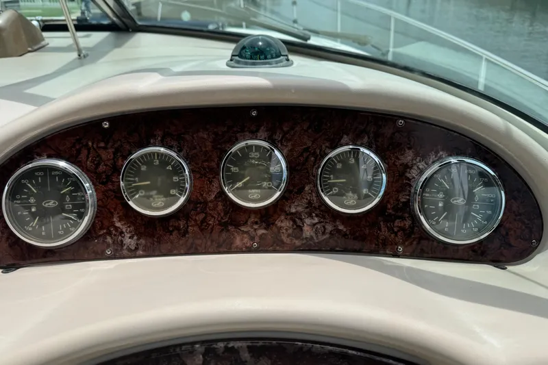 Slide: The Image of Dashboard of a 2004 Sea Ray 340 Sundancer boat with gauges and compass. - 21
