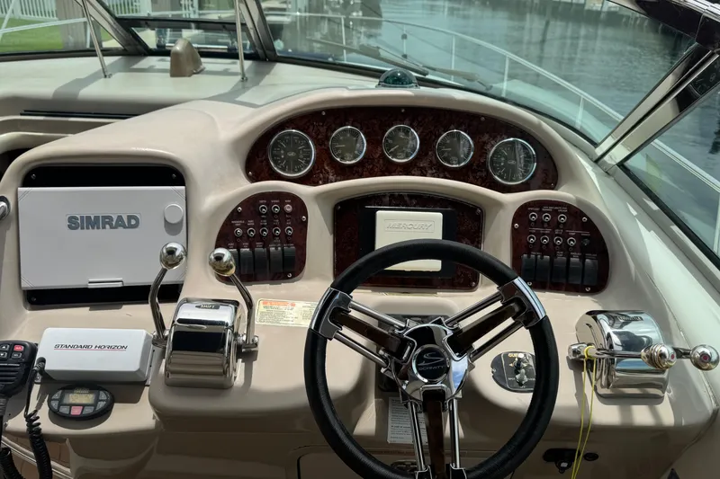 Slide: The Image of 2004 Sea Ray 340 Sundancer helm with Simrad navigation and Mercury controls. - 12
