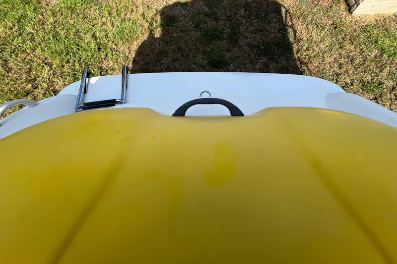 Slide: The Image of 2004 Sea-Doo Sportster LE DI boat with yellow deck and ladder, on grassy surface. - 34