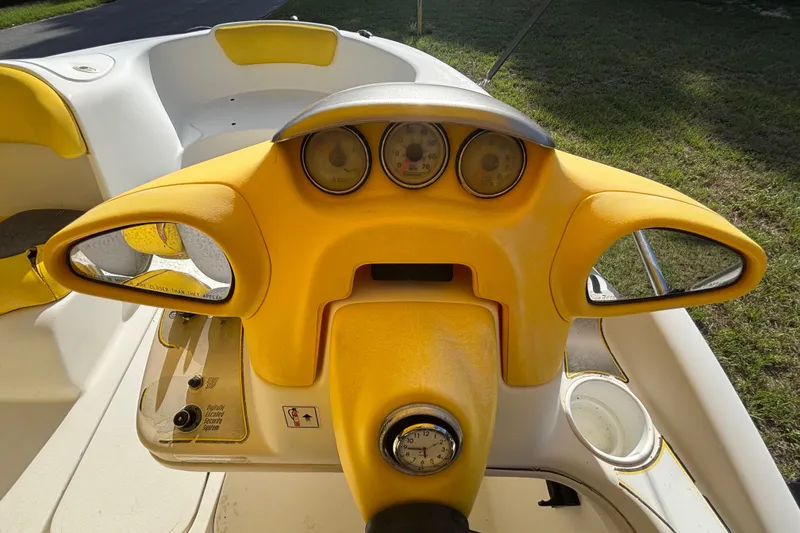 Slide: The Image of 2004 Sea-Doo Sportster LE DI dashboard with yellow accents and gauges. - 15
