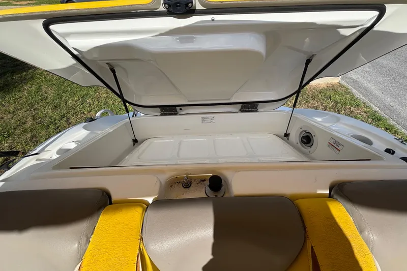 Slide: The Image of 2004 Sea-Doo Sportster LE DI boat interior storage compartment open, showcasing seating and hatch. - 32
