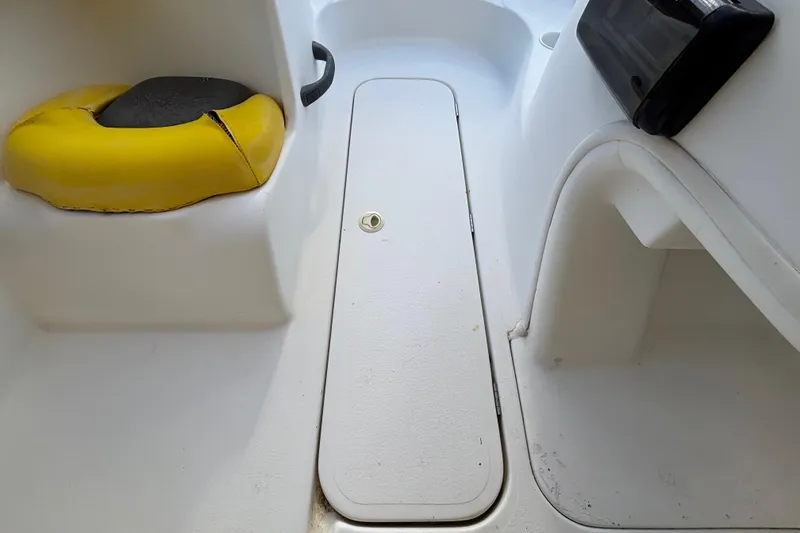 Slide: The Image of 2004 Sea-Doo Sportster LE DI interior with yellow seat and storage compartment. - 25