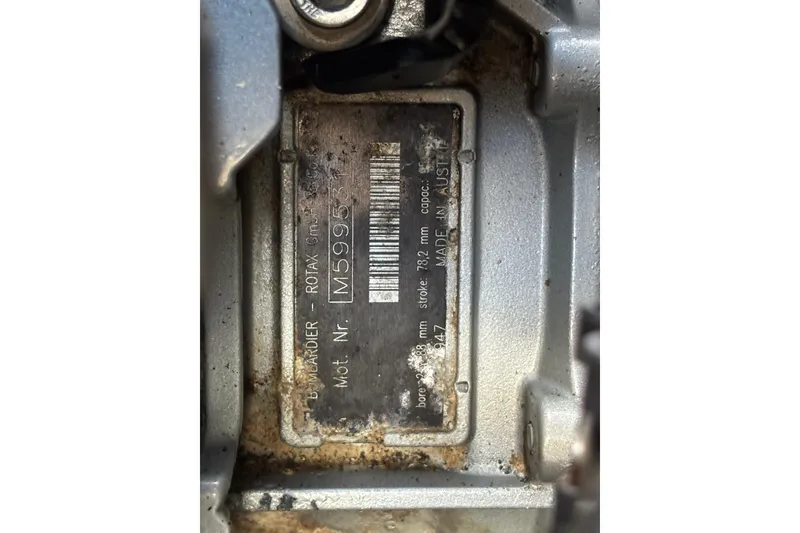 Slide: The Image of 2004 Sea-Doo Sportster LE DI engine plate with serial number and specifications. - 43